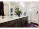 Modern bathroom features dual sinks, granite countertops, walk-in shower and wood look flooring at 6225 Gambetta St, Las Vegas, NV 89115