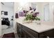 Bathroom with wood-look tile flooring, double sinks, and a purple rug at 6225 Gambetta St, Las Vegas, NV 89115
