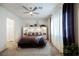 Bedroom with ceiling fan, carpet, large window and purple curtains at 6225 Gambetta St, Las Vegas, NV 89115