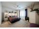 Bright bedroom with carpet, ceiling fan, and large window with curtains at 6225 Gambetta St, Las Vegas, NV 89115