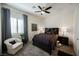 A bedroom with gray curtains, an armchair, and an area rug at 6225 Gambetta St, Las Vegas, NV 89115