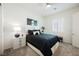 This bedroom features a black comforter, a modern nightstand, and a ceiling fan at 6225 Gambetta St, Las Vegas, NV 89115