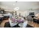 Open dining area showcasing a modern chandelier, seating for six, and seamless flow to the living spaces at 6225 Gambetta St, Las Vegas, NV 89115