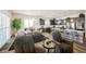 Open dining room with a modern chandelier, gray chairs, and access to living room and kitchen at 6225 Gambetta St, Las Vegas, NV 89115