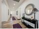 Hallway with a console table, decorative mirror, and purple area rugs at 6225 Gambetta St, Las Vegas, NV 89115