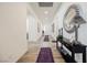 Hallway with a console table, decorative mirror, and purple area rugs at 6225 Gambetta St, Las Vegas, NV 89115