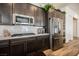 The kitchen features stainless appliances, light countertops, and dark wood cabinetry at 6225 Gambetta St, Las Vegas, NV 89115
