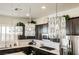 This kitchen has modern pendant lighting, stainless appliances, and a light counter top at 6225 Gambetta St, Las Vegas, NV 89115