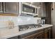 This kitchen has a gas cooktop, white backsplash, and stainless steel microwave at 6225 Gambetta St, Las Vegas, NV 89115