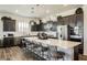 The bright kitchen features a large island, stainless appliances, pendant lighting, and dark wood cabinetry at 6225 Gambetta St, Las Vegas, NV 89115