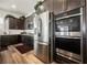 The gourmet kitchen has stainless steel appliances, dark wood cabinetry and light countertops at 6225 Gambetta St, Las Vegas, NV 89115