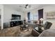 Cozy living room showcasing a comfortable seating arrangement, a ceiling fan, and light-filled windows at 6225 Gambetta St, Las Vegas, NV 89115