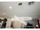 Modern chandelier lighting fixture in living room with kitchen in background at 6225 Gambetta St, Las Vegas, NV 89115