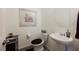 Cozy powder room features pedestal sink, modern lighting and framed mirror at 6225 Gambetta St, Las Vegas, NV 89115
