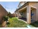 Grassy backyard featuring a covered patio with string lights, a slide, and mature landscaping at 6308 Gulf Waters St, North Las Vegas, NV 89081