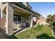 Backyard oasis featuring covered patio, lush lawn, and a play area, perfect for outdoor living at 6308 Gulf Waters St, North Las Vegas, NV 89081