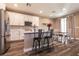 Modern kitchen with white cabinets, stainless appliances, and an island with barstool seating at 6308 Gulf Waters St, North Las Vegas, NV 89081