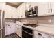 Contemporary kitchen with stainless steel appliances, white cabinets, and stone counter tops at 6308 Gulf Waters St, North Las Vegas, NV 89081