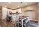 Bright kitchen with white cabinetry, stainless steel appliances, and an island with seating at 6308 Gulf Waters St, North Las Vegas, NV 89081