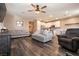 Open-concept living room with wood-look flooring and a view of the kitchen and dining area at 6308 Gulf Waters St, North Las Vegas, NV 89081