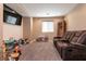 Upstairs loft with carpeting, television and a brown recliner at 6308 Gulf Waters St, North Las Vegas, NV 89081