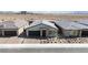 Aerial view of a single-story home with a gray roof, desert landscaping, and a two-car garage at 6726 N Palmer Estates St, North Las Vegas, NV 89086