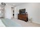 Well-lit bedroom with a large dresser, TV, and ensuite bathroom at 6726 N Palmer Estates St, North Las Vegas, NV 89086