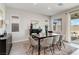 Bright dining area with table, chairs, decorative rug, and natural light from windows at 6726 N Palmer Estates St, North Las Vegas, NV 89086