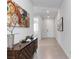 Bright entryway with tiled floors, modern console table, and contemporary artwork at 6726 N Palmer Estates St, North Las Vegas, NV 89086