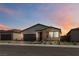 Beautiful single-story home featuring a two-car garage and desert landscaping at dusk at 6726 N Palmer Estates St, North Las Vegas, NV 89086