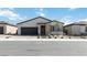 Charming single-story home with gray exterior, dark gray garage door, and desert landscaping at 6726 N Palmer Estates St, North Las Vegas, NV 89086