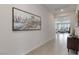 Long hallway with tiled floors leading to a bright living area with ample natural light at 6726 N Palmer Estates St, North Las Vegas, NV 89086