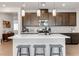 Beautiful kitchen island with quartz countertops, stainless steel appliances, and dark cabinets at 6726 N Palmer Estates St, North Las Vegas, NV 89086
