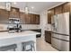Beautiful kitchen featuring stainless appliances, quartz countertops, dark wood cabinets, tile backsplash and a large island at 6726 N Palmer Estates St, North Las Vegas, NV 89086