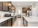 Beautiful gourmet kitchen featuring stainless steel appliances, quartz countertops, dark wood cabinets, and ample counter space at 6726 N Palmer Estates St, North Las Vegas, NV 89086