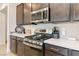 Modern kitchen boasts stainless steel appliances, quartz countertops, tile backsplash, and ample counter space at 6726 N Palmer Estates St, North Las Vegas, NV 89086