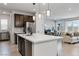 Modern kitchen with stainless steel appliances, large island, and open floor plan at 6726 N Palmer Estates St, North Las Vegas, NV 89086
