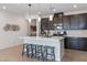 Modern kitchen with stainless steel appliances, a large island, and stylish pendant lighting at 6726 N Palmer Estates St, North Las Vegas, NV 89086