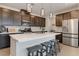 Kitchen with stainless appliances, quartz countertops, center island, and pendant lighting at 6726 N Palmer Estates St, North Las Vegas, NV 89086