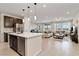 Open-concept kitchen with stainless steel appliances flows into the bright and spacious living room with lots of natural light at 6726 N Palmer Estates St, North Las Vegas, NV 89086