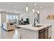 Open concept living space with modern lighting, comfortable seating, and large windows at 6726 N Palmer Estates St, North Las Vegas, NV 89086