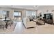 Open-concept living room with a dining area, sliding glass doors, and neutral decor at 6726 N Palmer Estates St, North Las Vegas, NV 89086