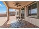 Comfortable covered patio with brick flooring, ceiling fan, and table setting with two chairs at 6726 N Palmer Estates St, North Las Vegas, NV 89086