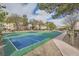Community basketball court with vibrant green and blue surfaces, surrounded by trees at 6745 Caporetto Ln # 104, North Las Vegas, NV 89084
