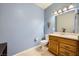 Bathroom with a single sink vanity, tiled floor, and soft blue walls at 6745 Caporetto Ln # 104, North Las Vegas, NV 89084