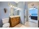 Bathroom featuring a vanity sink, tiled flooring, and access to a bedroom at 6745 Caporetto Ln # 104, North Las Vegas, NV 89084