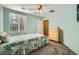 Comfortable bedroom featuring a ceiling fan and a view through the window at 6745 Caporetto Ln # 104, North Las Vegas, NV 89084