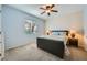 Comfortable bedroom with a ceiling fan, carpeted floor, and a large window at 6745 Caporetto Ln # 104, North Las Vegas, NV 89084