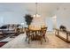 Open dining area with a round table, tile flooring, and a decorative plant at 6745 Caporetto Ln # 104, North Las Vegas, NV 89084