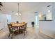 Bright dining area featuring a round table, tile flooring, and modern lighting at 6745 Caporetto Ln # 104, North Las Vegas, NV 89084